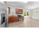 Modern kitchen features stainless steel appliances, wood cabinets, granite counters, and light wood floors at 125 Occidental Dr, Holly Springs, NC 27540