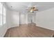 Open living room featuring ceiling fan and hardwood flooring at 125 Occidental Dr, Holly Springs, NC 27540