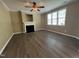 Inviting living room featuring a cozy fireplace, neutral walls, and elegant flooring at 125 Occidental Dr, Holly Springs, NC 27540