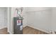 Utility room with water heater and wire shelving for storage at 125 Occidental Dr, Holly Springs, NC 27540