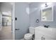 Updated bathroom with modern vanity, sleek fixtures, and views to the nearby kitchen at 1317 Proctor St, Rocky Mount, NC 27801