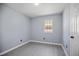 Bedroom with light gray walls, modern light-colored flooring, and natural light from a window at 1317 Proctor St, Rocky Mount, NC 27801