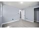 A bedroom with light grey walls, bright floors, and access to an en-suite bathroom and closet at 1317 Proctor St, Rocky Mount, NC 27801
