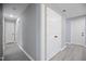 Hallway with gray walls and bright floors, showcasing access to multiple rooms with white doors at 1317 Proctor St, Rocky Mount, NC 27801