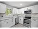 Bright kitchen with stainless steel appliances, white cabinets, and natural light at 1317 Proctor St, Rocky Mount, NC 27801
