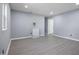 Bright living room with new gray flooring, fresh paint, and recessed lighting at 1317 Proctor St, Rocky Mount, NC 27801