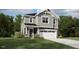 Charming two-story home features a classic design, a two-car garage and manicured lawn at 135 Vulcan St, Garner, NC 27529