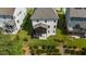 Aerial view of the backyard, patio, and landscaping nestled between neighboring homes at 1632 Ferntree Ct, Morrisville, NC 27560