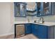 Stylish wet bar with glass cabinets, quartz countertops, and beverage cooler at 1632 Ferntree Ct, Morrisville, NC 27560