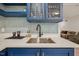 Wet bar area with sink, cabinets and seating. The bar has a backsplash at 1632 Ferntree Ct, Morrisville, NC 27560