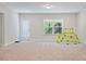 Large carpeted basement area with ample natural light and walkout access at 1632 Ferntree Ct, Morrisville, NC 27560