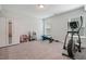 Carpeted basement featuring exercise equipment, storage closet and a play area at 1632 Ferntree Ct, Morrisville, NC 27560