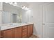 Bathroom featuring double sinks, vanity, cabinets, a large mirror and bright lighting at 1632 Ferntree Ct, Morrisville, NC 27560