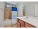 Well-lit bathroom featuring a shower-tub combo with modern fixtures and tile at 1632 Ferntree Ct, Morrisville, NC 27560