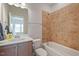 Bathroom with tiled tub, shower, and sink at 1632 Ferntree Ct, Morrisville, NC 27560