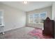 Bedroom featuring a large window, carpet flooring and neutral-colored walls at 1632 Ferntree Ct, Morrisville, NC 27560