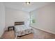 Cozy bedroom with neutral walls, carpet, and a comfortable bed near a bright window at 1632 Ferntree Ct, Morrisville, NC 27560