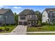 Charming two-story home with brick facade, covered front porch, and well-manicured lawn at 1632 Ferntree Ct, Morrisville, NC 27560