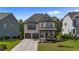 Charming two-story home with brick facade, covered front porch, and well-manicured lawn at 1632 Ferntree Ct, Morrisville, NC 27560
