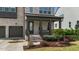Inviting front porch with covered entry, brick columns, and landscaped garden at 1632 Ferntree Ct, Morrisville, NC 27560