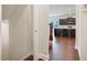 Hallway view towards kitchen with dark wood cabinets and breakfast bar seating at 1632 Ferntree Ct, Morrisville, NC 27560