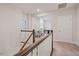 Upstairs hallway featuring wood and white railing leading to rooms at 1632 Ferntree Ct, Morrisville, NC 27560
