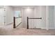 Upstairs hallway with white trim and neutral walls leading to other rooms at 1632 Ferntree Ct, Morrisville, NC 27560