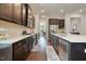 Modern kitchen with stainless steel appliances, dark cabinets, quartz countertops and wood flooring at 1632 Ferntree Ct, Morrisville, NC 27560