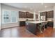 Spacious kitchen features a large island with seating, stainless appliances, and dark cabinets at 1632 Ferntree Ct, Morrisville, NC 27560