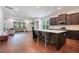 Open-concept kitchen with large island, stainless steel appliances, and adjacent living area at 1632 Ferntree Ct, Morrisville, NC 27560