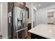 Stainless steel refrigerator with ice maker and large quartz countertop at 1632 Ferntree Ct, Morrisville, NC 27560