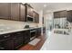 Well-equipped kitchen boasts stainless appliances, dark cabinets and eat in counter space at 1632 Ferntree Ct, Morrisville, NC 27560