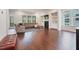Bright living room featuring dark hardwood floors, gray sectional sofa, fireplace and sliding glass door at 1632 Ferntree Ct, Morrisville, NC 27560