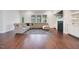 Spacious living room featuring a gray sectional sofa, fireplace, built-in shelves, and dark hardwood floors at 1632 Ferntree Ct, Morrisville, NC 27560