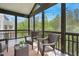 Relaxing screened porch with wicker chairs overlooking the green trees, providing privacy at 1632 Ferntree Ct, Morrisville, NC 27560