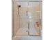 Glass shower stall with tile surround, seating and built-in shelving at 1632 Ferntree Ct, Morrisville, NC 27560