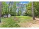 Expansive backyard with mature trees providing ample shade, featuring a storage shed at 1703 Cranston Road Rd, Garner, NC 27529