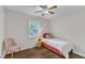 Cozy bedroom features wood flooring, a bright window, and a single bed at 1703 Cranston Road Rd, Garner, NC 27529