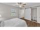 Bright bedroom with modern ceiling fan, closet with sliding barn door, and a window at 1703 Cranston Road Rd, Garner, NC 27529