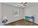 Bedroom featuring hardwood floors, a window with blinds, and a unique desk and chair at 1703 Cranston Road Rd, Garner, NC 27529