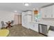 Bright kitchen boasts stainless steel appliances, white cabinets, and a stylish pendant light at 1703 Cranston Road Rd, Garner, NC 27529