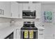 Close up of the kitchen with stainless steel appliances, white cabinets and countertops at 1703 Cranston Road Rd, Garner, NC 27529