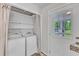 Functional laundry room with washer, dryer, storage shelves and exterior door at 1703 Cranston Road Rd, Garner, NC 27529