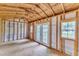 Bright outbuilding interior featuring wood framing, windows, and double doors for an ideal flex space or creative studio at 1703 Cranston Road Rd, Garner, NC 27529