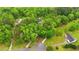 Expansive aerial view of a property nestled among lush trees, featuring multiple buildings and a winding driveway at 179 Carrie Dr, Archer Lodge, NC 27527