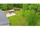 View of the backyard with outdoor kitchen and cozy fire pit at 179 Carrie Dr, Archer Lodge, NC 27527