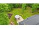 Aerial view of the backyard featuring a built in outdoor kitchen and fire pit with seating at 179 Carrie Dr, Archer Lodge, NC 27527