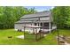 Rear exterior showcasing a spacious backyard with an outdoor kitchen, patio, and screened porch at 179 Carrie Dr, Archer Lodge, NC 27527