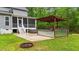 Spacious backyard with an outdoor kitchen, patio, and hot tub, perfect for gatherings at 179 Carrie Dr, Archer Lodge, NC 27527