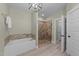 Bright bathroom featuring a soaking tub, glass shower, and neutral tones at 179 Carrie Dr, Archer Lodge, NC 27527